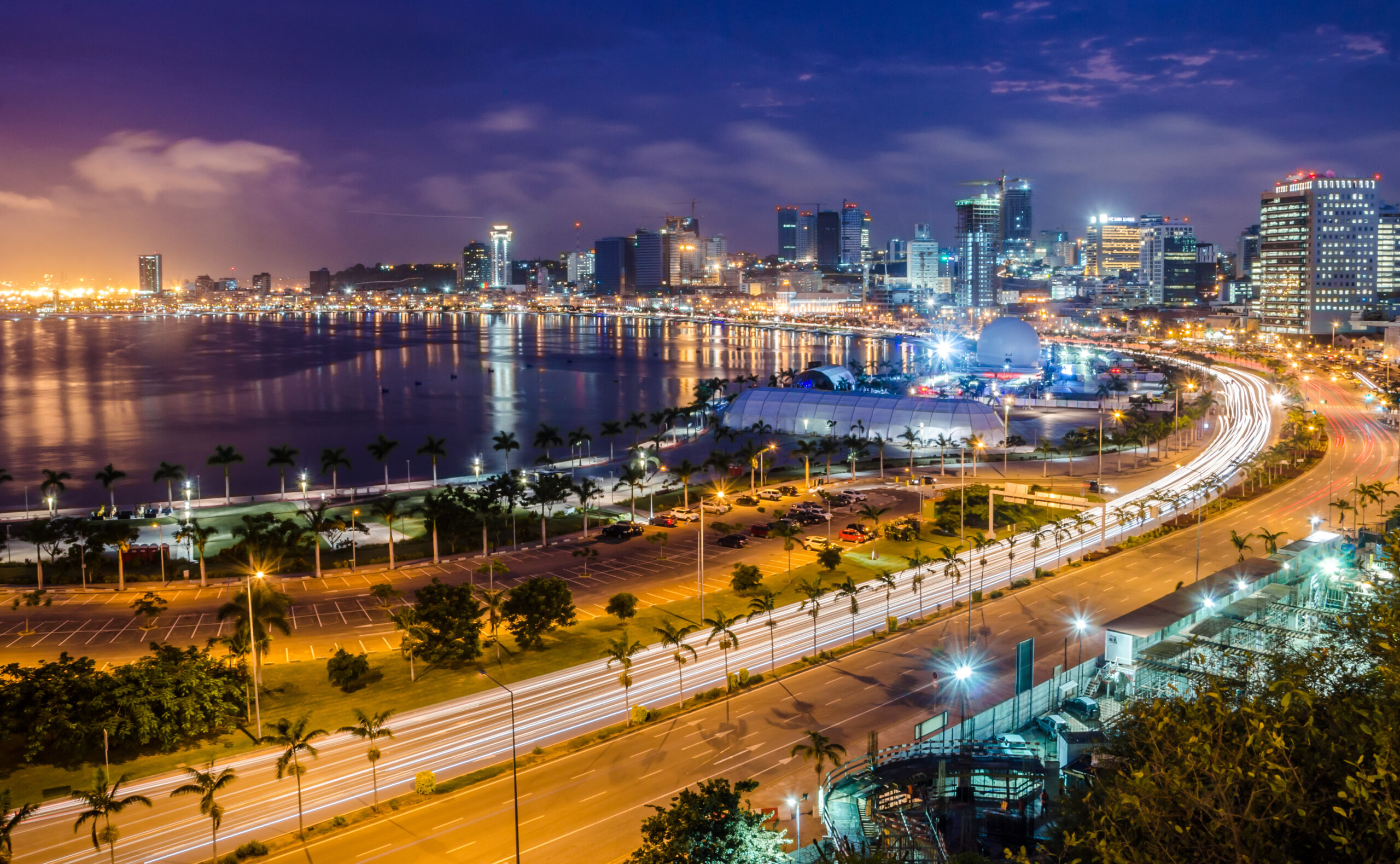 Skyline of capital city Luanda, Luanda bay and seaside promenade with highway during afternoon, Angola, Africa.